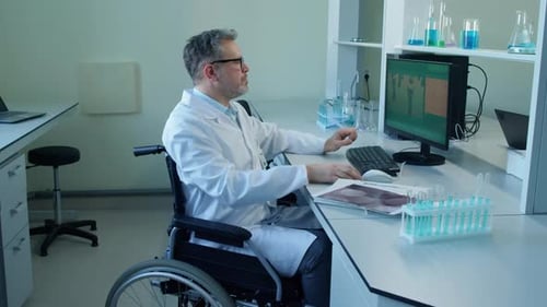 Scientist in Wheelchair Working in Medical Lab