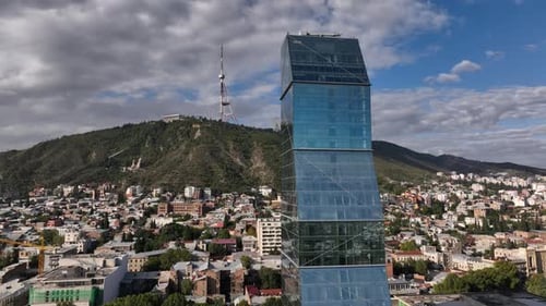 Flying over Shota Rustaveli avenue in the center of city. Aerial view of The Biltmore Tbilisi Hotel