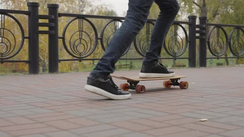 Closeup Young Man Feet Riding Skateboard Outdoor in Slow Motion