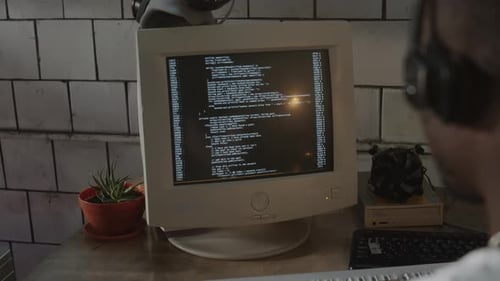 Programmer Coding on Old Computer in Post Apocalypse Bunker