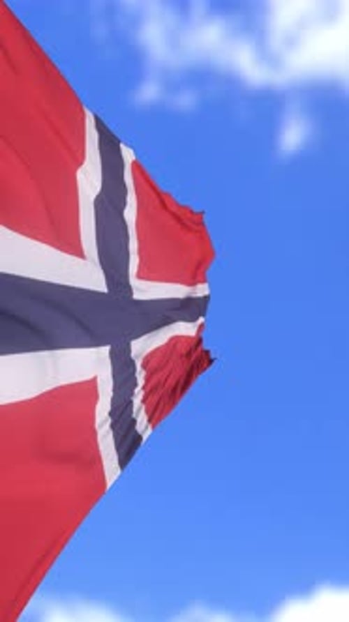 Patriotic Norway Flag Fluttering in Wind With Clear Sky Background