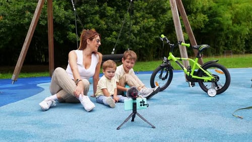 Mother and Children Vlogging at Playground with Bicycle