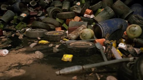 A Cluttered Site with Discarded Tires Containers and Debris