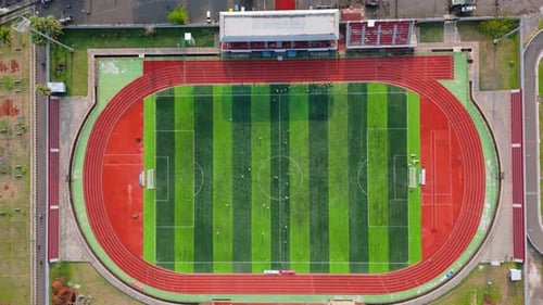 Aerial view from top of soccer field with football player. Football stadium. Outdoor sports