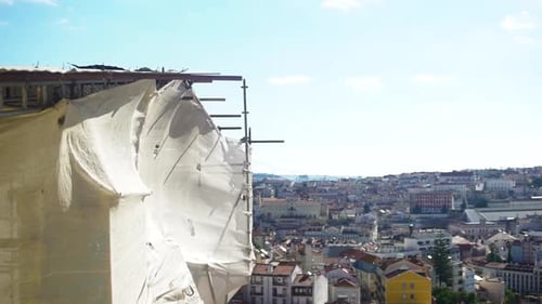Building Under Construction In Lisbon, With City View In Background.