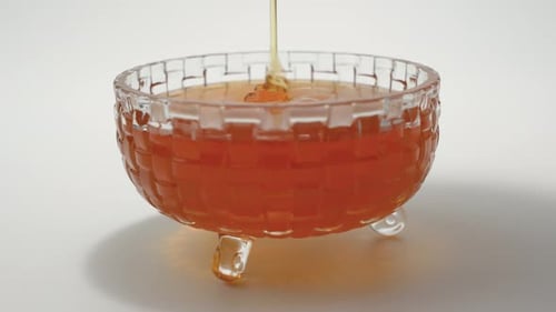 Honey Pouring into a Crystal Bowl Close Up