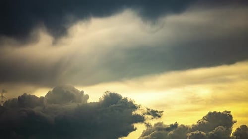 Timelapse dark storm clouds with golden bright sunset light, beautiful cloudscape