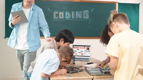 Group of diverse student working together while teacher hold tablet. Pedagogy.