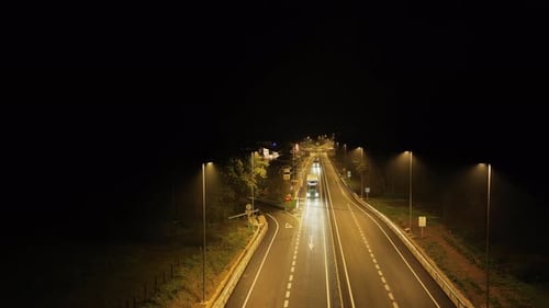 Freight Trucks on City Road at Night