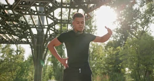 Man Warm Up Exercise Routine in Sunny Park