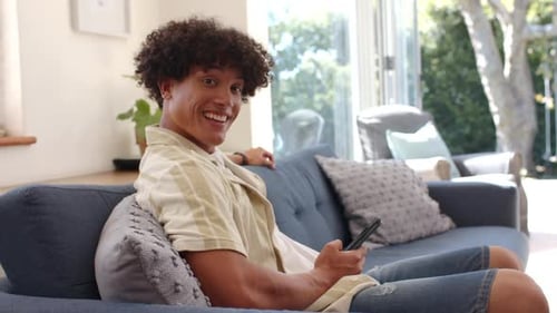 Young Man Relaxing on Couch with Phone