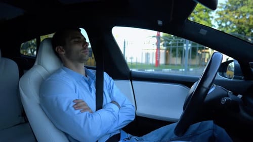 Male Businessperson Experience to Ride an Autonomous Self Driving Electric Car at Urban Road