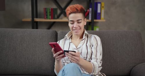 Woman Shopping Online with Smartphone and Credit Card