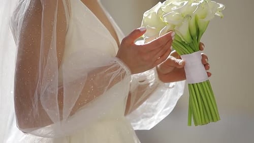 Close Up of the Bride Holding a Bouquet of White Flowers