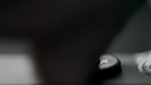 Closeup Hand of Anonymous Man Inserting Screw in Hole and Turning It with Electric Screwdriver Then