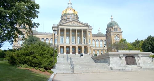 Walking up the steps at the des moines Iowa state capitol building on a sunny day