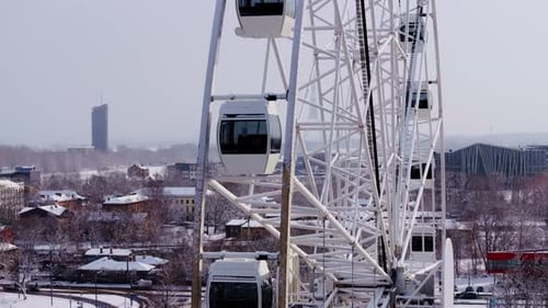Ferris Wheel Overlooking Winter City Landscape