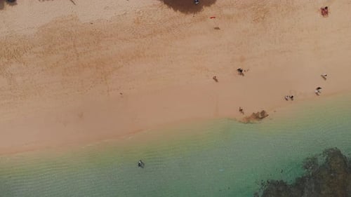 Top Aerial View on Sandy Ocean Shore with Resting Tourists Turquoise Water in Lagoon with Foamy Long