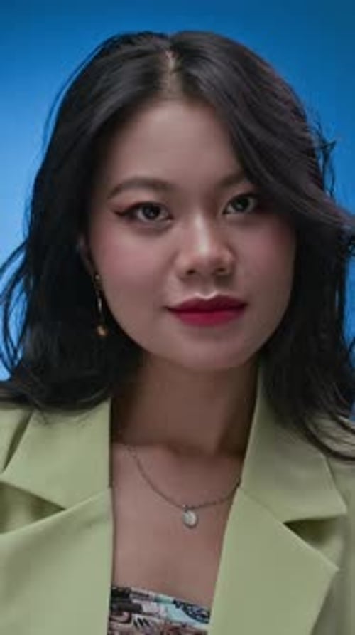 Stylish Person Smiling and Running Hands Through Hair