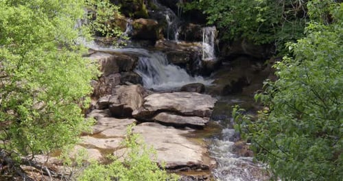 Wide Shot of East gill force, waterfall, through trees on the river swale, keld, Swaledale