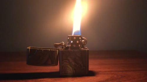 Lighter flame at night on a table