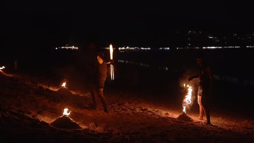 Nighttime Fire Performance on a Beach in Phuket or Phi Phi Islands