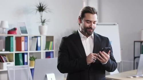 Male Businessman Using Mobile Phone at Office
