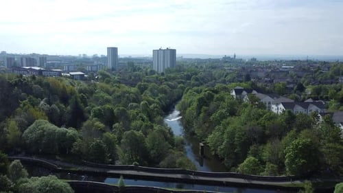 A stunning aerial view of a lush green urban landscape, featuring a mix of modern high-rise building