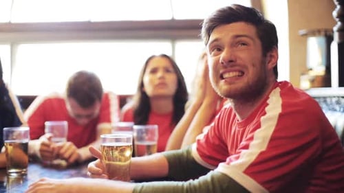 Friends Reacting with Joy and Disappointment in Pub