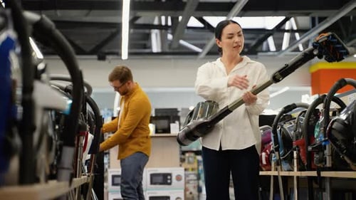Young Couple Buying New Vacuum Cleaner at Tech Store for New Home