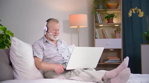 Senior Man Relaxing, Chatting Online, At Home