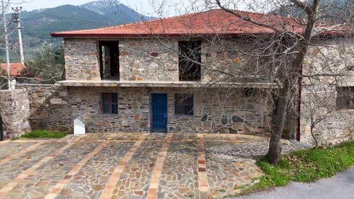 Drone View of Rustic Stone Country House with Red Tile Roof