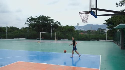 basketball player plays on the playground in the park