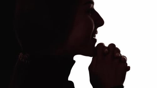 Woman Silhouette Contemplating with Clasping Hands