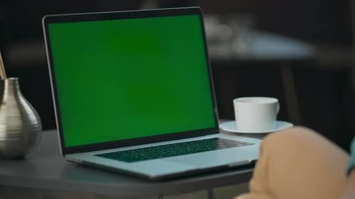 Unrecognizable director waving hello during green screen video call at modern office