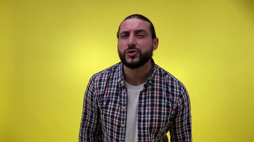 Man Making Faces on a Yellow Background