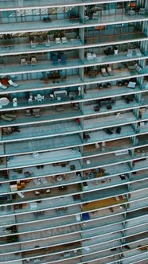 Descending along the huge residential block of flats with spacious balconies.