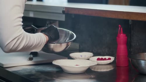 Male Chef Placing Marinated Tuna Cubes in Bowl in Restaurant Kitchen