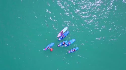 Aerial View of Paddleboarders in Turquoise Water