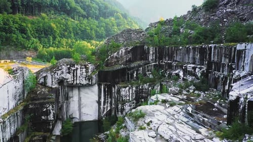 Drone Fly Down and Pan in Abandoned White Marble Quarry in Carrara Italy