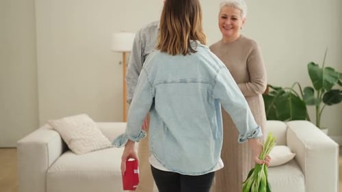 Happy Family Granddaughter Gives Gift Box Spring Tulip Flowers to Grandparents Teenage Girl with