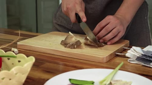 Adult Chopping Mushrooms in the Kitchen