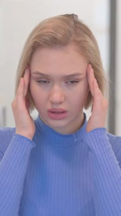 Portrait of Young Woman with Headache in Office, vertical video