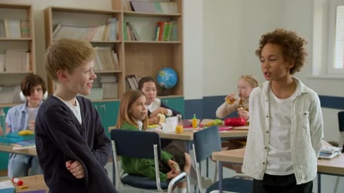 Elementary School Class Children Communicate with the Teacher Answering Question