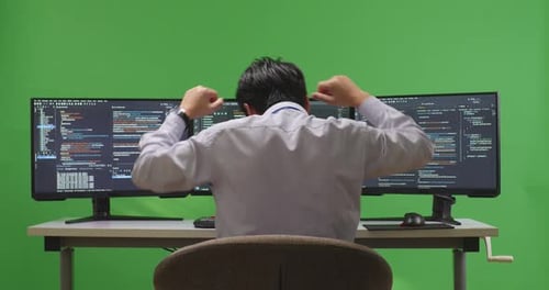 Developer Celebrating And Dancing While Write Code With Multiple Computer Screens In Green Screen