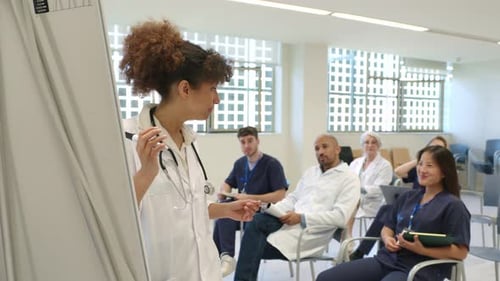 Medical Professional Giving Presentation to Seated Class