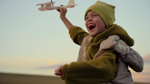 Little Boy Running with an Airplane