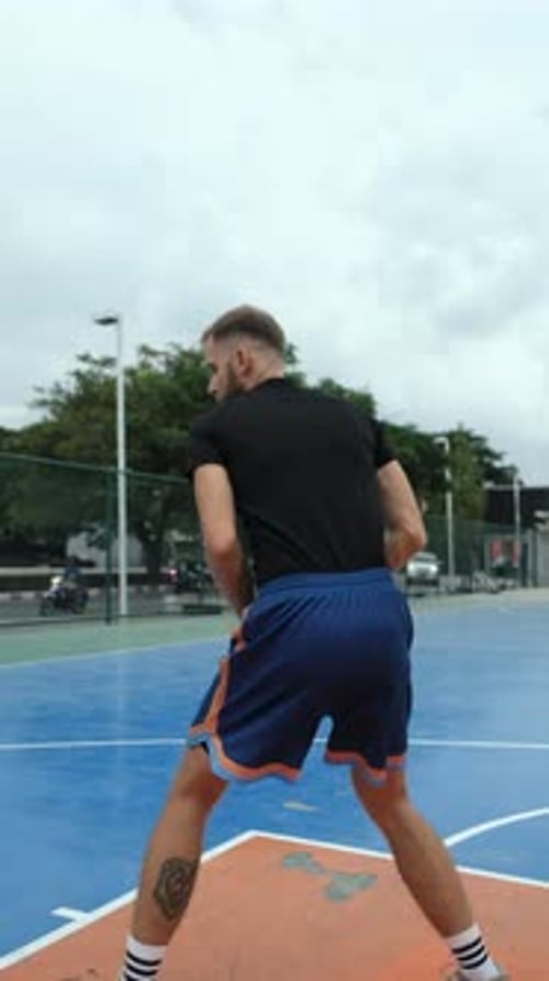 Man Dribbling and Shooting Basketball on Outdoor Court