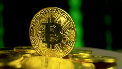 Bitcoin Cryptocurrency Coin on Reflective Surface