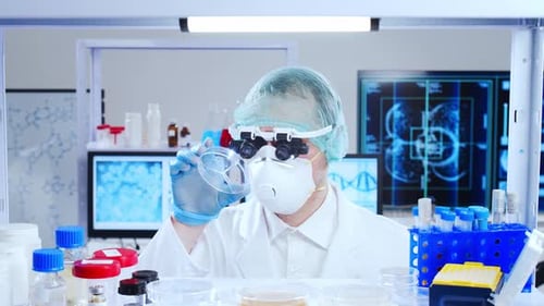 Scientist Examines Petri Dish in Bright Laboratory